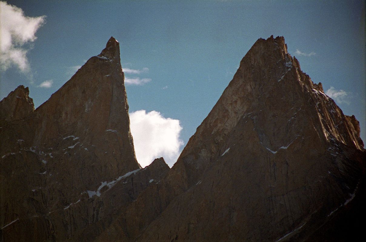 20 Lobsang Spire From Khoburtse Just After Sunrise The early morning sun shines on Lobsang Spire (5707m) from Khoburtse. Lobsang Spire was first climbed on June 13, 1983 alpine style by Doug Scott, Greg Child, and Pete Thexton. �It�s featureless up there. Impossible,� says Doug. 
Out comes the drill. 
 For two hours I hammer away on the fifteenth pitch, interspersing rivets with sequences of skyhooks balanced on tiny edges, in order that our ten rivets might last the 100 ft to the summit. When I step onto the final skyhook placed on the lip of the knife-edged summit I grab a handful of snow and sprinkle it onto Pete And Doug below. �A present from the summit,� I shout.� - Thin Air: Encounters in the Himalayas by Greg Child.